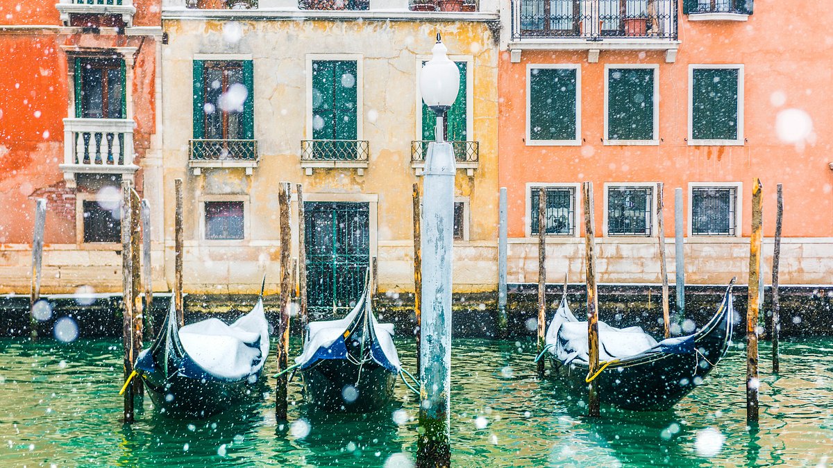 Snowfall over gondolas on the Grand Canal in Venice, Italy 