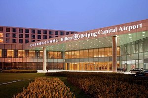 Hilton Beijing Capital Airport in Beijing, image may contain: Office Building, Building, Convention Center, Car