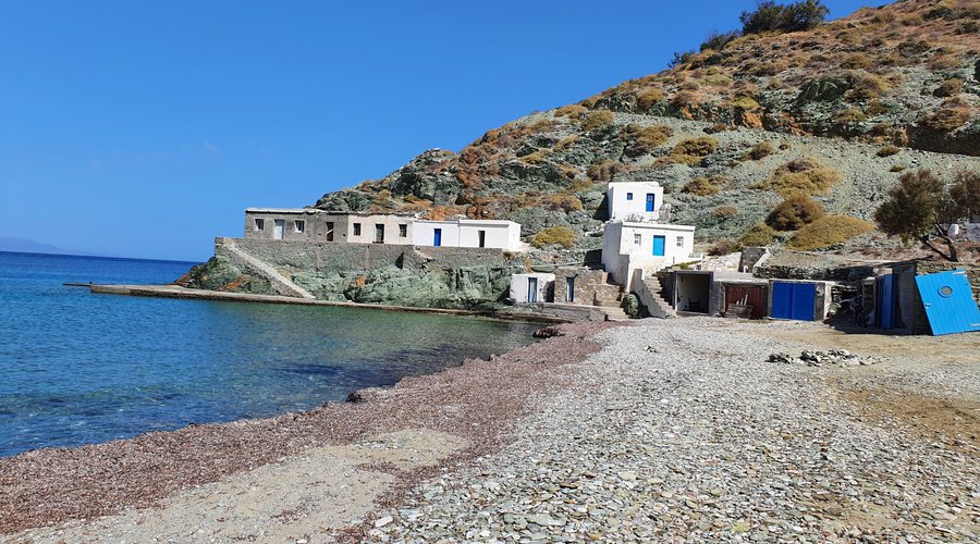 Old fishing houses at one end of beach.