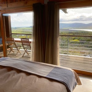 View from the bed of one of the self catering fynbos suites. The lake is Kraaiboschdam, the local water reservoir on the land of our neighbour Lomond Wine Estate.