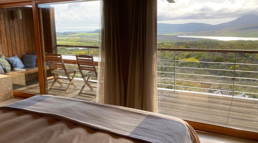 View from the bed of one of the self catering fynbos suites. The lake is Kraaiboschdam, the local water reservoir on the land of our neighbour Lomond Wine Estate.