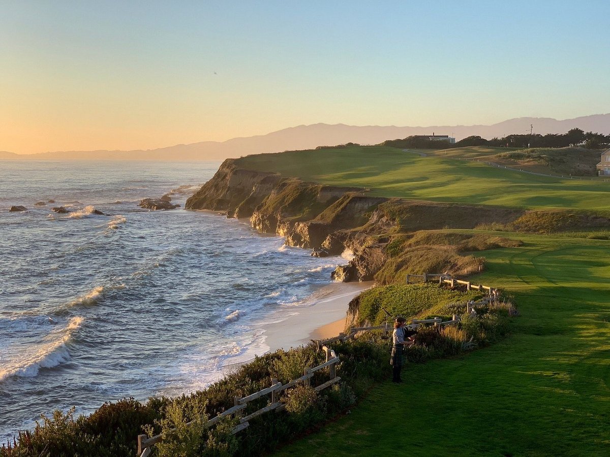 Oceanfront cliffs and adjacent golf course at sunset