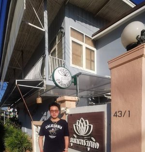 In front of the little hotel.