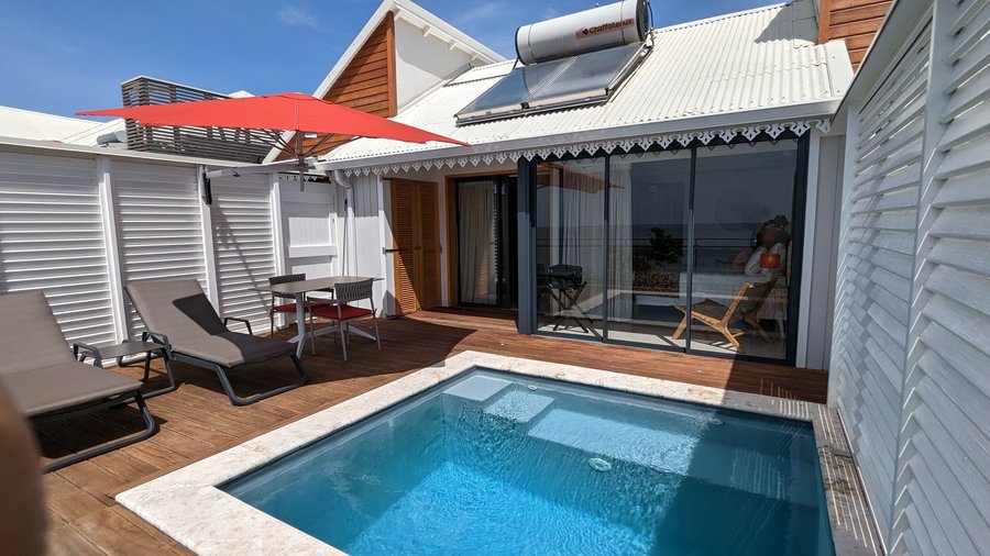 The outdoor of the suite with your own kitchen table pool and transats