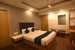 Hotel Prag Continental in Guwahati, image may contain: Bed, Furniture, Bedroom, Room