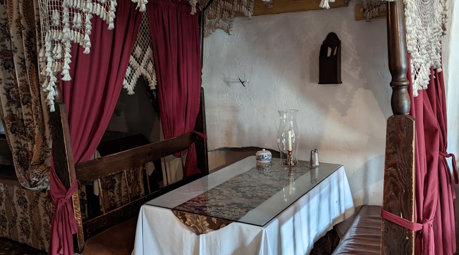 Some tables have bed curtains for privacy and decor