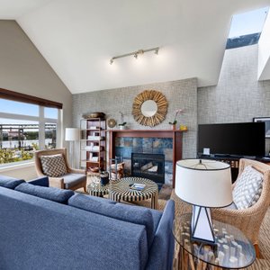 Full kitchen, living room with fireplace, dining area and balcony