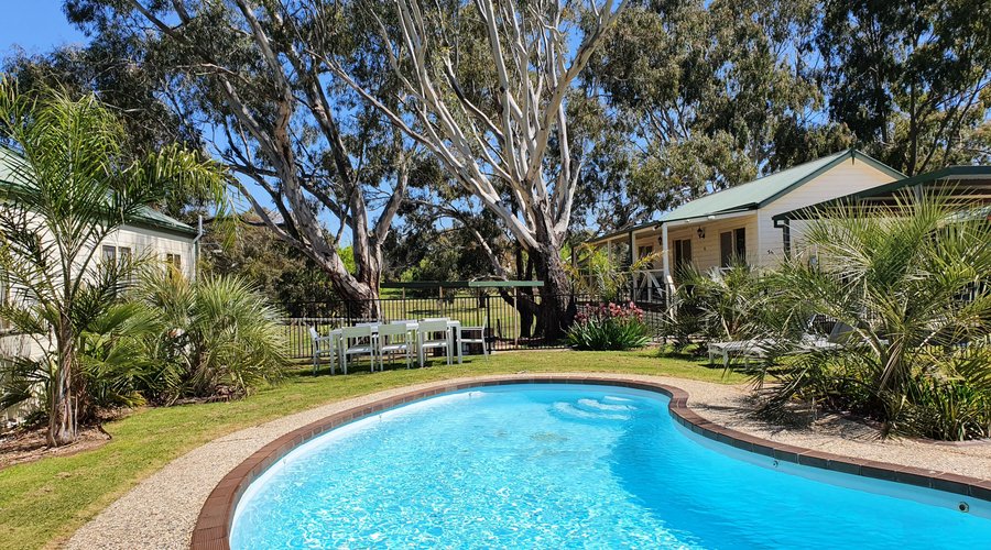 Outdoor Pool area with lounge chairs and outdoor dining 