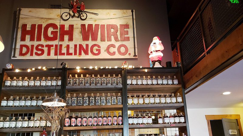 Wall of whiskey and gin at High Wire Distilling Co.