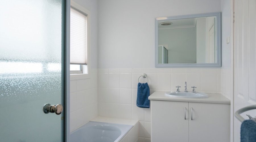 Amani House's second bathroom with separate toilet and additional vanity.