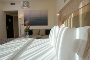 Toledo Hotel in Amman, image may contain: Couch, Furniture, Interior Design, Bedroom
