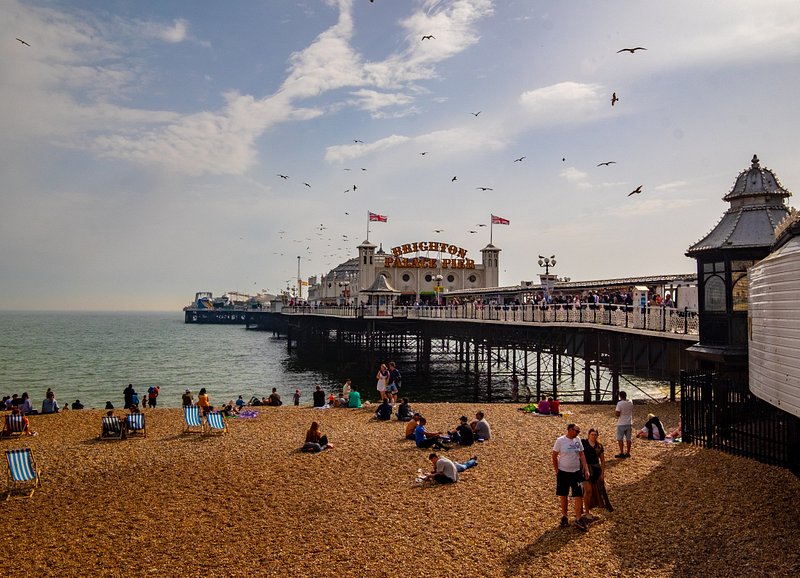 People near the Brighton Palace Pier viewing the ocean