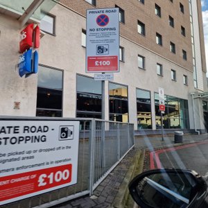 Note the very tiny sign underneath the big one that says "Hotel Users Drop Off Only".  Even with that message they will still fine you. 