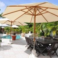 Blooming garden at pooldeck with umbrellas for shade.