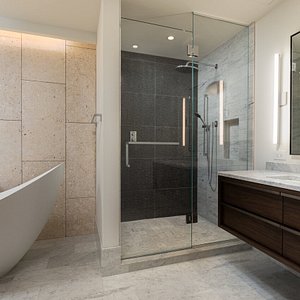 Master bath has two sink areas, an overhead shower and large soaking bathtub.