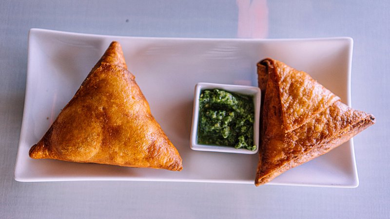 A plate of crispy, golden vegetarian sambusas served inside Lalibela