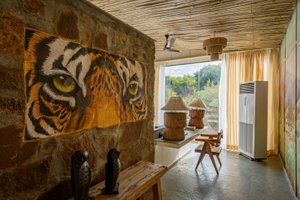 Utsav Camp Sariska in Nadoo, image may contain: Interior Design, Wood, Chandelier, Ceiling Fan