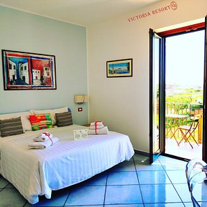 Victoria Resort in Marina di Ascea, image may contain: Door, Bed, Furniture, Chair