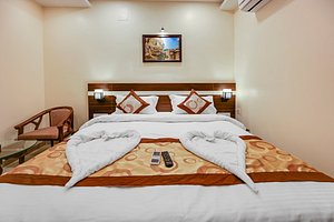 Hotel SJ Pride in Bhubaneswar, image may contain: Remote Control, Furniture, Home Decor, Interior Design