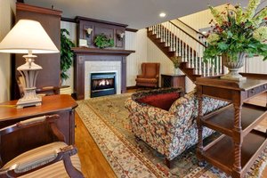 Country Inn & Suites by Radisson, London South, ON in London, image may contain: Home Decor, Staircase, Living Room, Fireplace