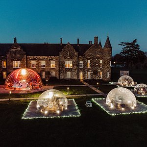 Amazing capture of our 800 year old manor house, 4 luxury dining domes and Titan Sky Bar dome on a winters evening. 