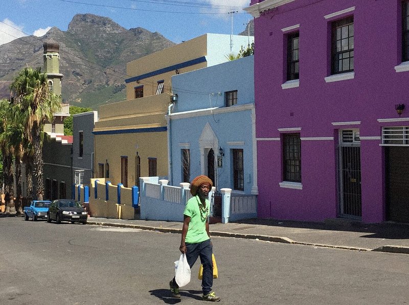 Local man in South Africa walking with mountains in the background