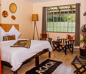 Acacia Tree Lodge in Nairobi, image may contain: Home Decor, Bed, Furniture, Lamp