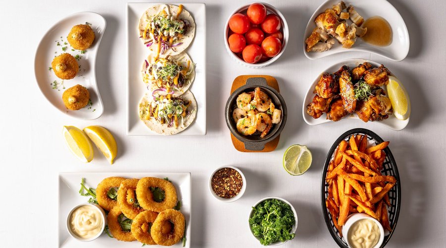 Bar Snacks and Starters Arancini, Mini Beef Tacos, Pork Belly BitesSizzling Garlic Prawns, Buffalo Wings Onion Rings and Sweet Potato Chips