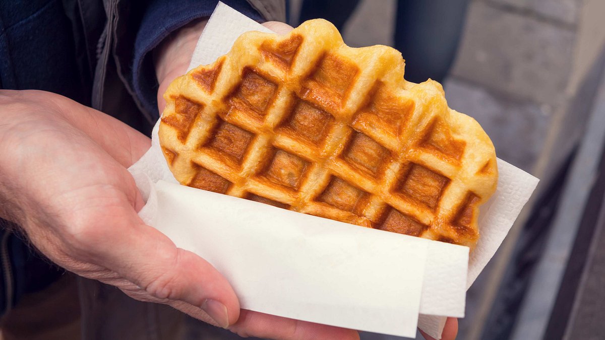 Person holding a Belgian Waffle wrapped in paper