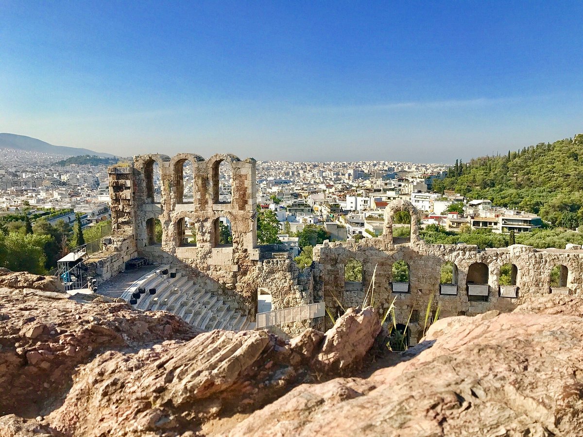 A view of ancient Acropolis and modern Athens beyond from the top of a hill