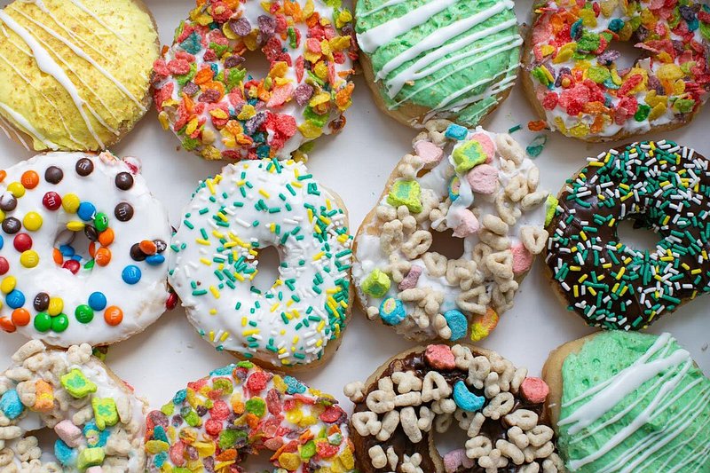 12 decorative doughnuts with sprinkles, cereal, and colorful icing