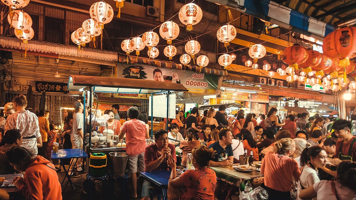 People eating street food in the Chinatown neighborhood of Bangkok, Thailand 