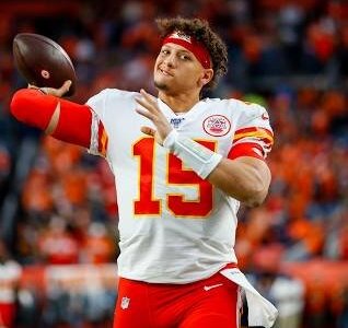 Patrick Mahomes about to throw on the sideline.