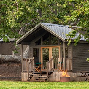 Cedar cabins have peak ceilings, private bathrooms, private bedrooms, kitchenette, and picnic table.