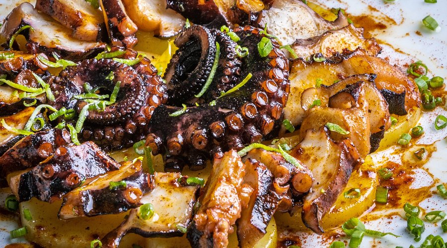 Galician-Style Octopus, eaten in the rough-and-ready polbeirias found throughout Galicia. Originally brought to Galicia from the coast by cattle traders, the octopus was preserved, packed in olive oil and paprika, and eaten at fairs (thus its other name, pulpo a feira). Luckily, now we no longer have to rely on preserved octopus. It's a simple but delicate dish: this pairing of sea and field is divine!   el iberico pulpo a la Gallega  #pulpoalagallega #comida #restaurante 