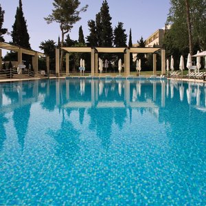 Swimming pool surrounded by landscaped Gardens