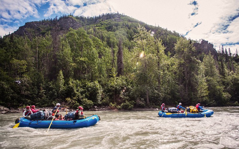 A group of travelers whitewater rafting in Wells Gray Park, Canada