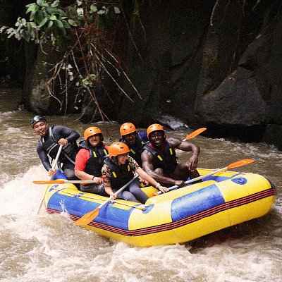 A group of travelers whitewater rafting in Bali