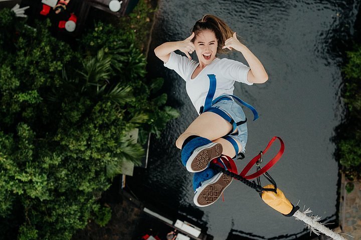 A lady smiling while bungee jumping in Cairns, Australia
