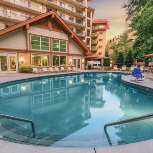 Outdoor pool surrounded by sunchairs.