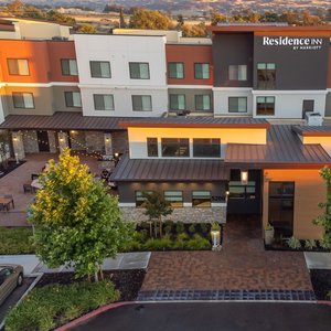 Exterior view of hotel at sunset with mountains