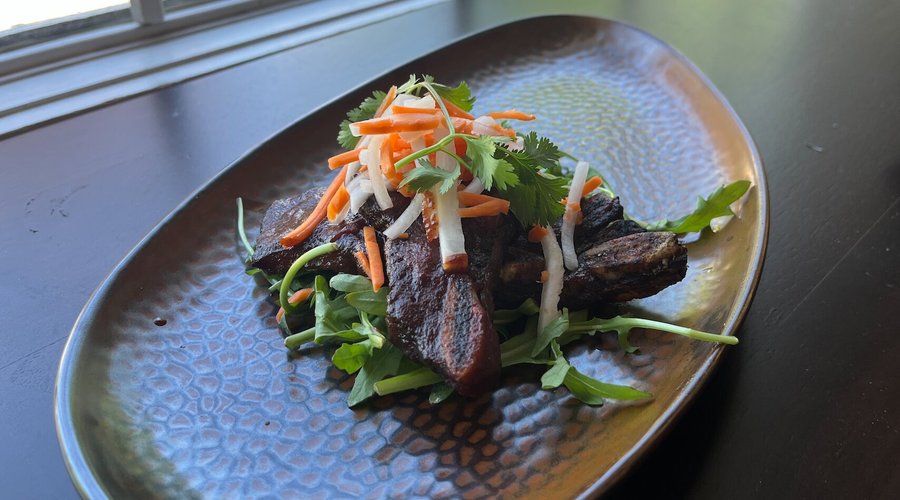 Bootleggers Beef - Flanken Cut Beef Ribs Braised Slow & Low then Brushed with a Sweet & Spicy Glaze, Garnished with Pickled Carrot and Daikon