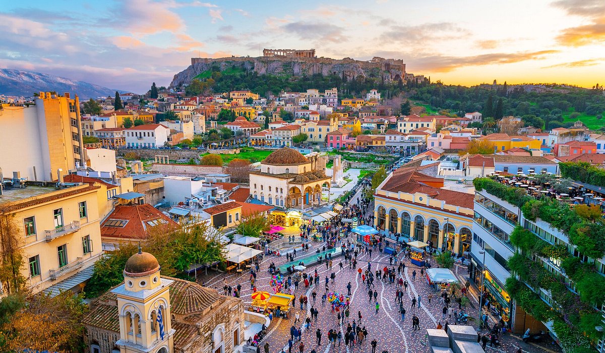 A view of the buildings and square in old town Athens with the Acropolis in the distance