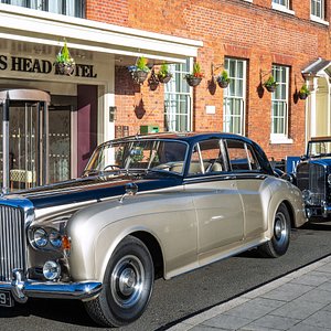 Hotel exterior with vintage Bentleys