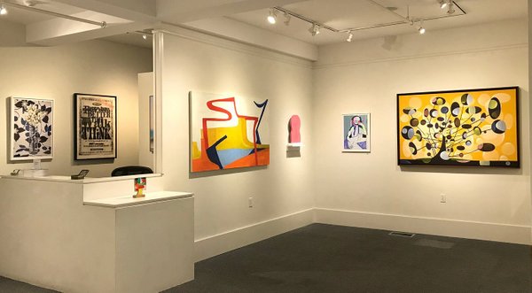Art gallery with various works hung on the walls