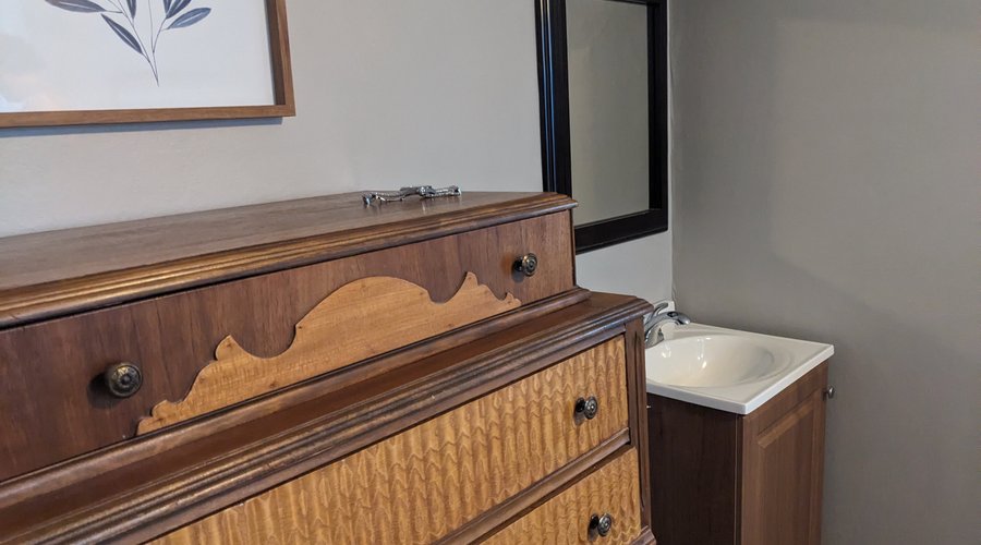 A little sink and dresser are in Room 14. 