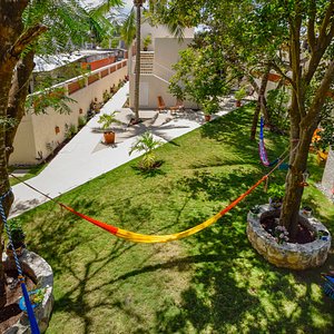 Our beautiful, shared garden with hammocks and lounge chairs fit for relaxing.