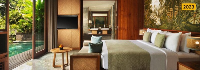 A spacious, comfortable villa with a pool and lush greenery beyond the sliding door