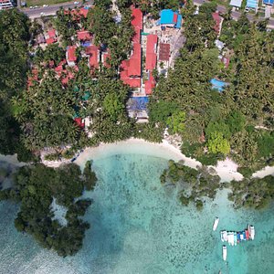 Wide View from Drone of Resort showing beach, swimming pool, our boats, and whole resort