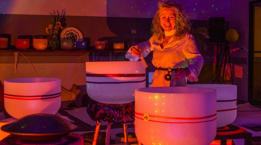 Gigi Turner PsyD. playing singing bowls during a sound bath event in Colorado Springs, CO